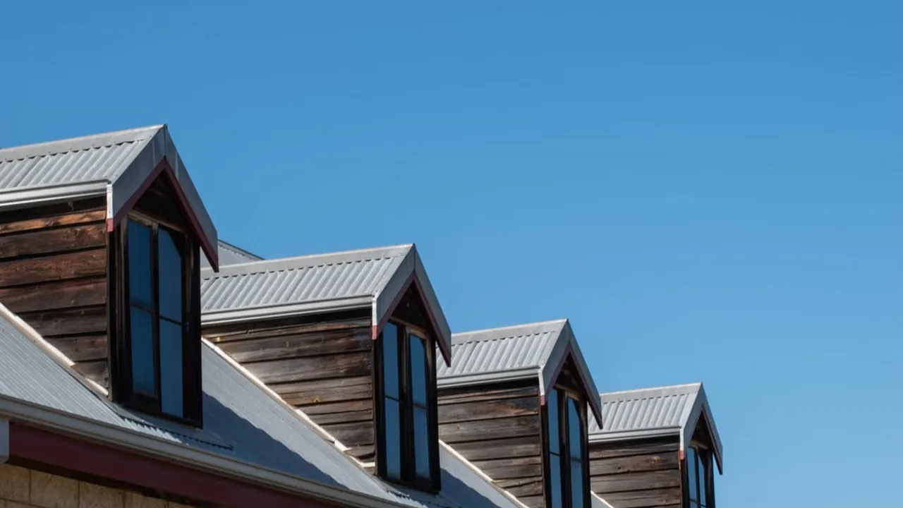 Triangular rooftops against a clear sky