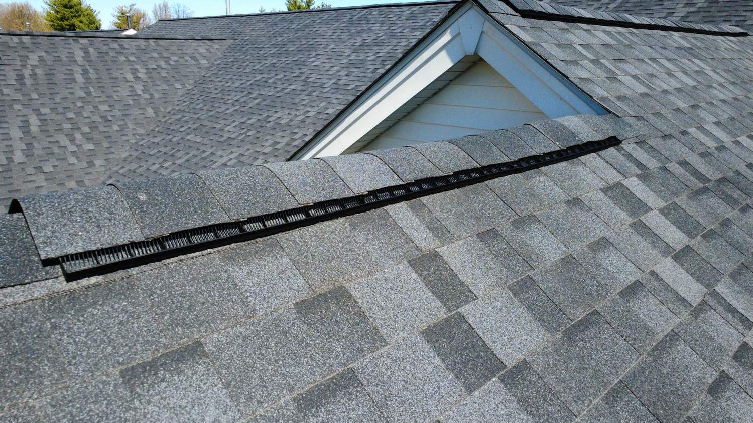 Aerial of a large completed roof with low-slope sections by Emmendorfer Exteriors in Franklin County, Missouri
