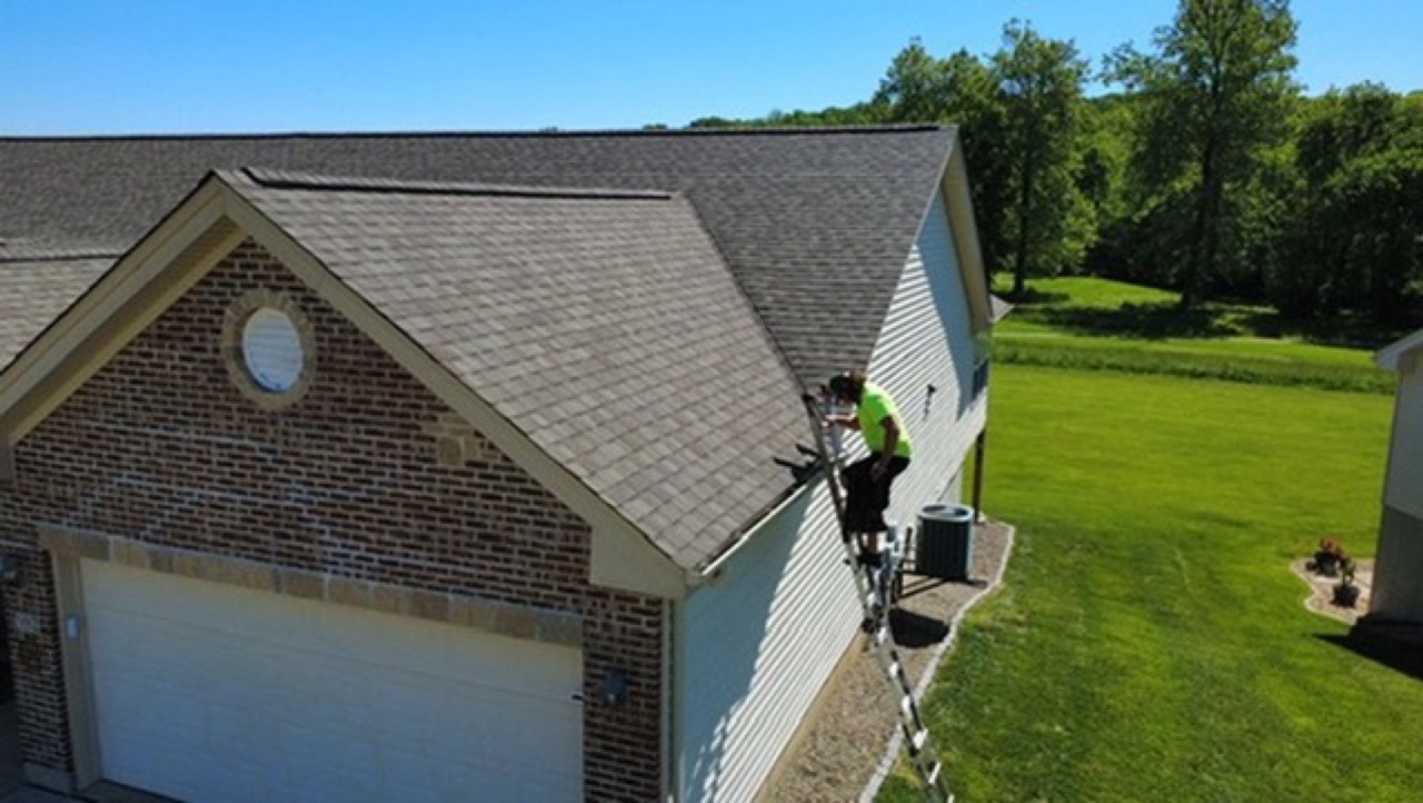 New gutters installed alongside a roof and siding job